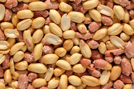 A detailed close-up image of roasted peanuts in their shells, showcasing texture.